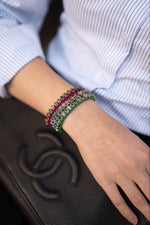 Woman wearing three colours from the Caravan of Stones mini collection. Bespoke real diamond and gemstone bracelets.