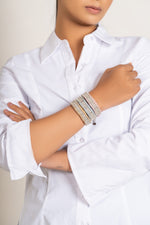 A close-up of a person wearing Caravan of Stones Stackers against a plain light background.