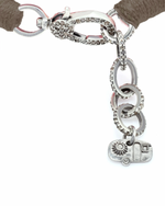 Bracelet with brown threads and diamond, silver charm on a white background.