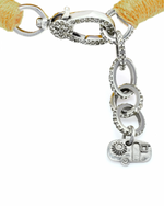 Bracelet with yellow threads and diamond, silver charm on a white background.