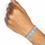 Baby blue Row diamond bracelet worn on a wrist with a sliding closure
