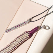 The Caravan of Stones LOVE Necklace in its pink gift box: pavé diamond sterling silver pendant with rubies spelling LOVE in Morse code, on a black cord