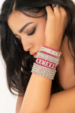 Woman wearing a pink-thread Caravan of Stones diamond bracelets with natural pavé diamonds.