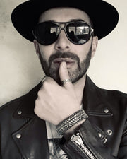 British fashion designer Scott Henshall wearing the Caravan of Stones Ibiza natural diamond bracelet on black thread