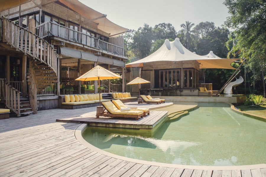 Villa 21 at Soneva Kiri with its freeform pool, waterslide and tented pavilions