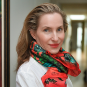 Caron Founder of Caravan of Stones wearing a colourful scarf and white shirt.