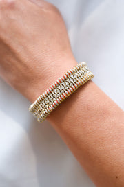 Close-up of a luxury handmade coral thread bracelet with real diamonds on a woman's wrist. 