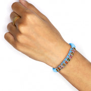 Baby blue Mini Lisse bracelet with multicoloured gemstones worn on a wrist
