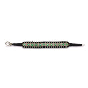Side view of black thread bracelet with emerald settings and diamond detailing