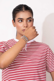 Caravan of Stones mini diamond bracelets layered on the wrist with pavé-set diamonds on colourful thread