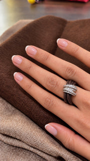 The Diamond Ring in Cotton worn on the hand: brown braided cotton cord through a pavé diamond sterling silver band
