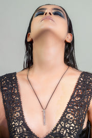 Model in black lace wearing The LOVE Necklace by Caravan of Stones