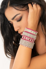 Woman wearing a pink-thread Caravan of Stones diamond bracelets with natural pavé diamonds.
