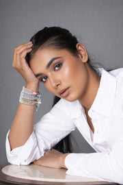 Caravan of Stones stacker diamond bracelets layered on the wrist with pavé-set diamonds on colourful thread