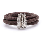 Front view of The Diamond Ring in Cotton by Caravan of Stones: brown braided cotton cord wrapped twice through a curved sterling silver band pavé-set with natural diamonds