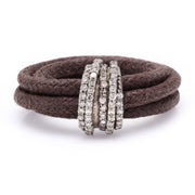 Front view of The Diamond Ring in Cotton by Caravan of Stones: brown braided cotton cord wrapped twice through a curved sterling silver band pavé-set with natural diamonds