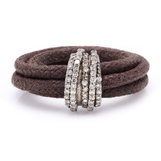 Front view of The Diamond Ring in Cotton by Caravan of Stones: brown braided cotton cord wrapped twice through a curved sterling silver band pavé-set with natural diamonds