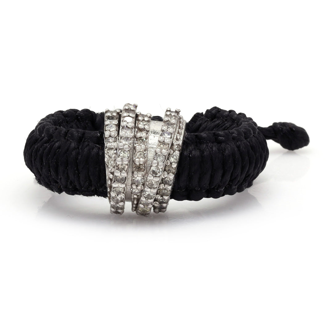 Front view of The Diamond Ring in Linhasita by Caravan of Stones in Black: braided waxed thread through a curved sterling silver band pavé-set with natural diamonds