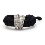 Front view of The Diamond Ring in Linhasita by Caravan of Stones in Black: braided waxed thread through a curved sterling silver band pavé-set with natural diamonds