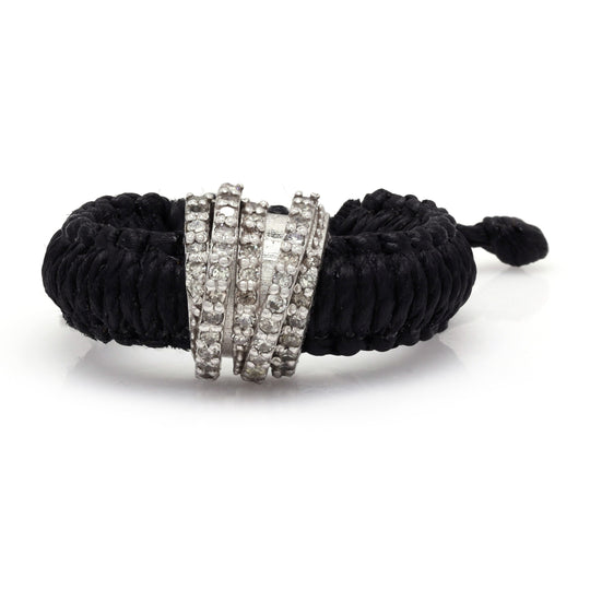 Front view of The Diamond Ring in Linhasita by Caravan of Stones in Black: braided waxed thread through a curved sterling silver band pavé-set with natural diamonds