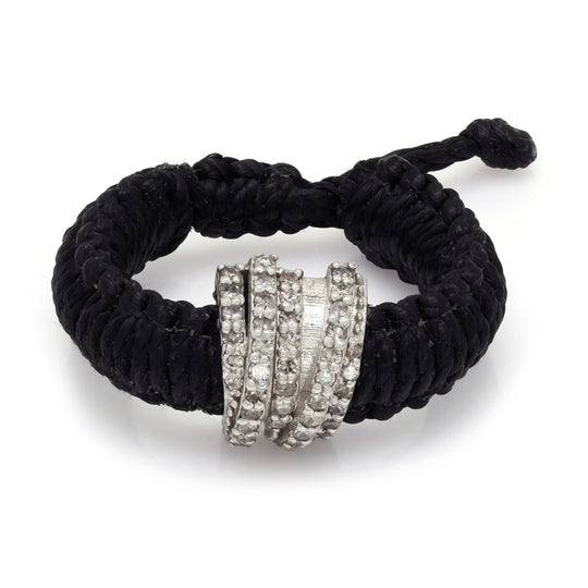 Top view of The Diamond Ring in Black Linhasita: pavé diamond sterling silver band on braided waxed thread with adjustable sliding knot
