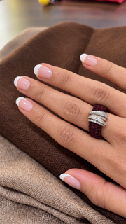 The Diamond Ring in Vampire Claret Linhasita by Caravan of Stones, with a continuous knotted thread band and pavé diamond silver detail, worn on a hand.