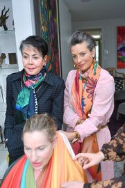 Three women wearing colourful scarves during a colour analysis session
