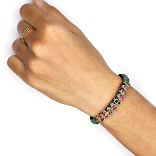 Deep petrol teal Mini Lisse bracelet with multicoloured gemstones worn on a wrist