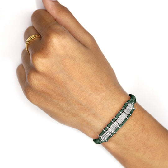 Hand wearing a Deep Petrol Teal Row Bracelet on a white background
