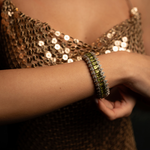 Forte dei Marmi sand thread diamond and peridot bracelet worn with a sequinned top