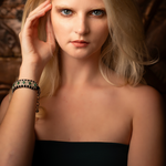 London black thread pavé diamond and emerald bracelet worn on a wrist
