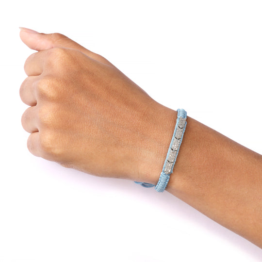 Méridien baby blue bracelet worn on a wrist against a white background