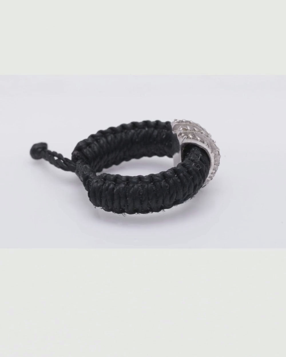 The Diamond Ring by Caravan of Stones in black Linhasita, turning to show the pavé diamond sterling silver collet