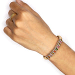 Hand wearing a Saddle Camel Mini Lisse Bracelet on a white background