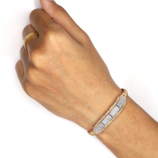 Hand wearing a Saddle Camel Row Bracelet on a white background