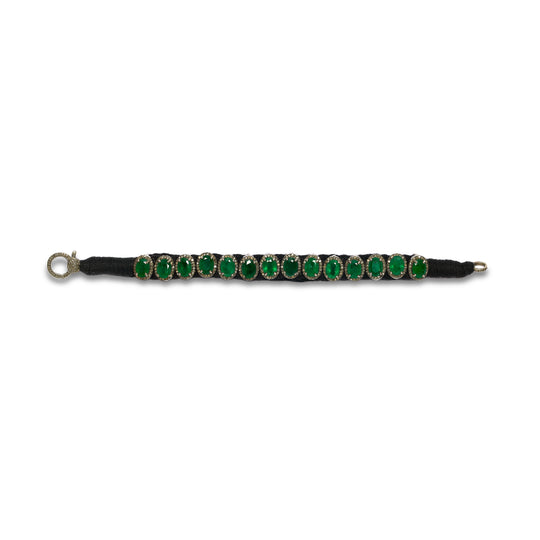 Venice black thread pavé diamond and emerald bracelet laid flat